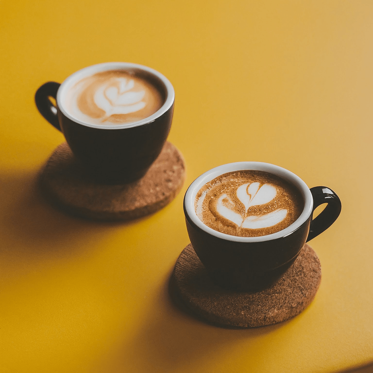 AI Design for two cups of coffee on table with yellow background, cozy home atmosphere with space for text in the middle