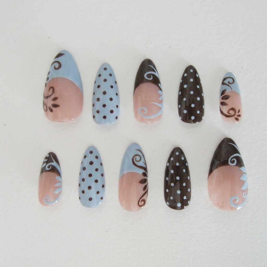 AI Design for in this nail set change the white to light dusty blue and the black into brown do not change the nude pink base colour