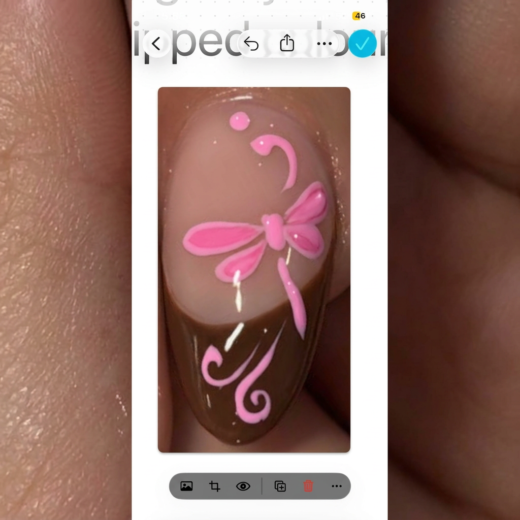 AI Design for change the pink French nail and brown and change the 2-D art design into pink. Keep the nude base colour and change. Nothing else about this photo.
