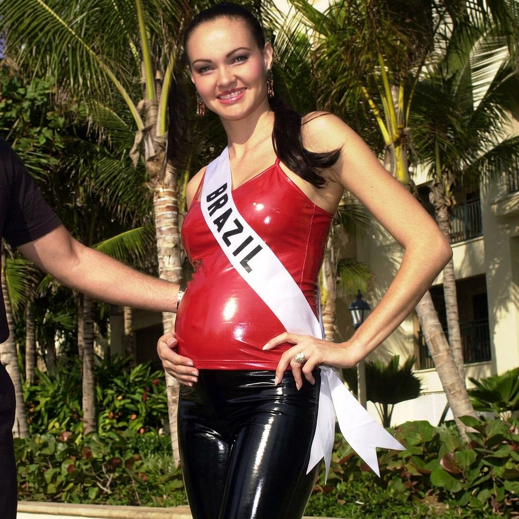AI Design for she wears shiny and reflective fitted cami woman red tank top and she is pregnant and she wears black leather socks and black tight shiny leather leggings