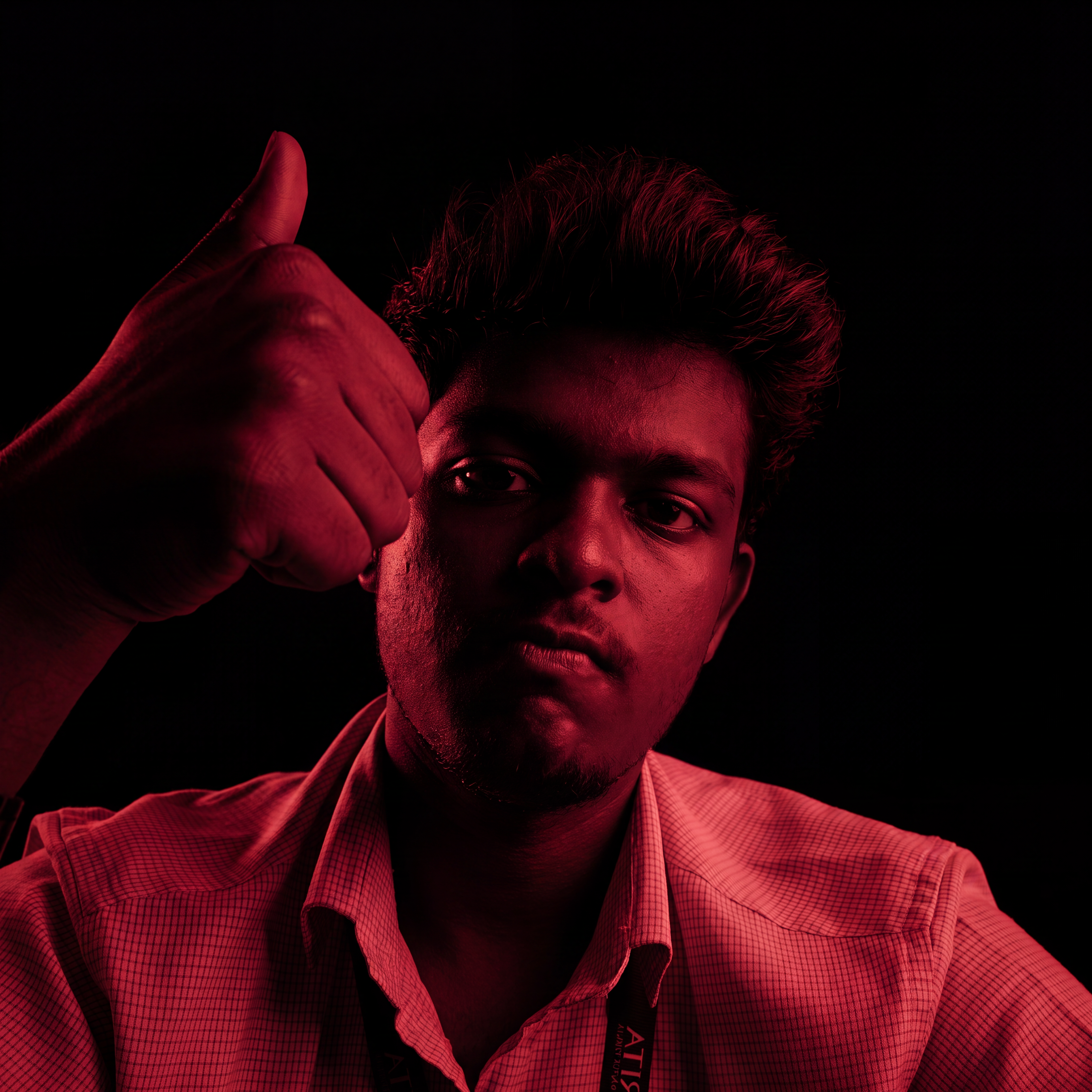 AI Design for Cinematic portrait, straight-on facial expression, hyper-realistic skin texture. Dramatic duotone lighting using only deep matte black (#000000) and rich crimson red (#B00020). Intense crimson directional side lighting sculpting the cheekbones, jawline, and hair texture, transitioning into deep black shadows on the opposite side. Minimalist, solid black background. Premium luxury fashion editorial aesthetic, high-contrast film noir style, sharp facial details, volumetric lighting, 8k resolution, photorealistic, no text, no logos. Use the attached image as the primary composition and structural reference.