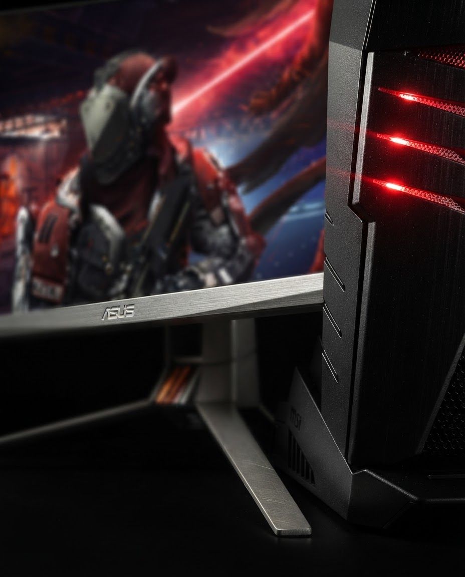 AI Design for Macro detail photograph of Performance Gaming Setup highlighting material quality, finish, texture, or signature product detail. The image features a gaming PC tower and an ultra-wide monitor set against a black background. The hardware has a matte black finish with prominent red LED lighting accents, displaying a digital fantasy combat scene on the screen. Premium close-up lighting, tactile realism, shallow depth of field, product detail sharp and accurate.