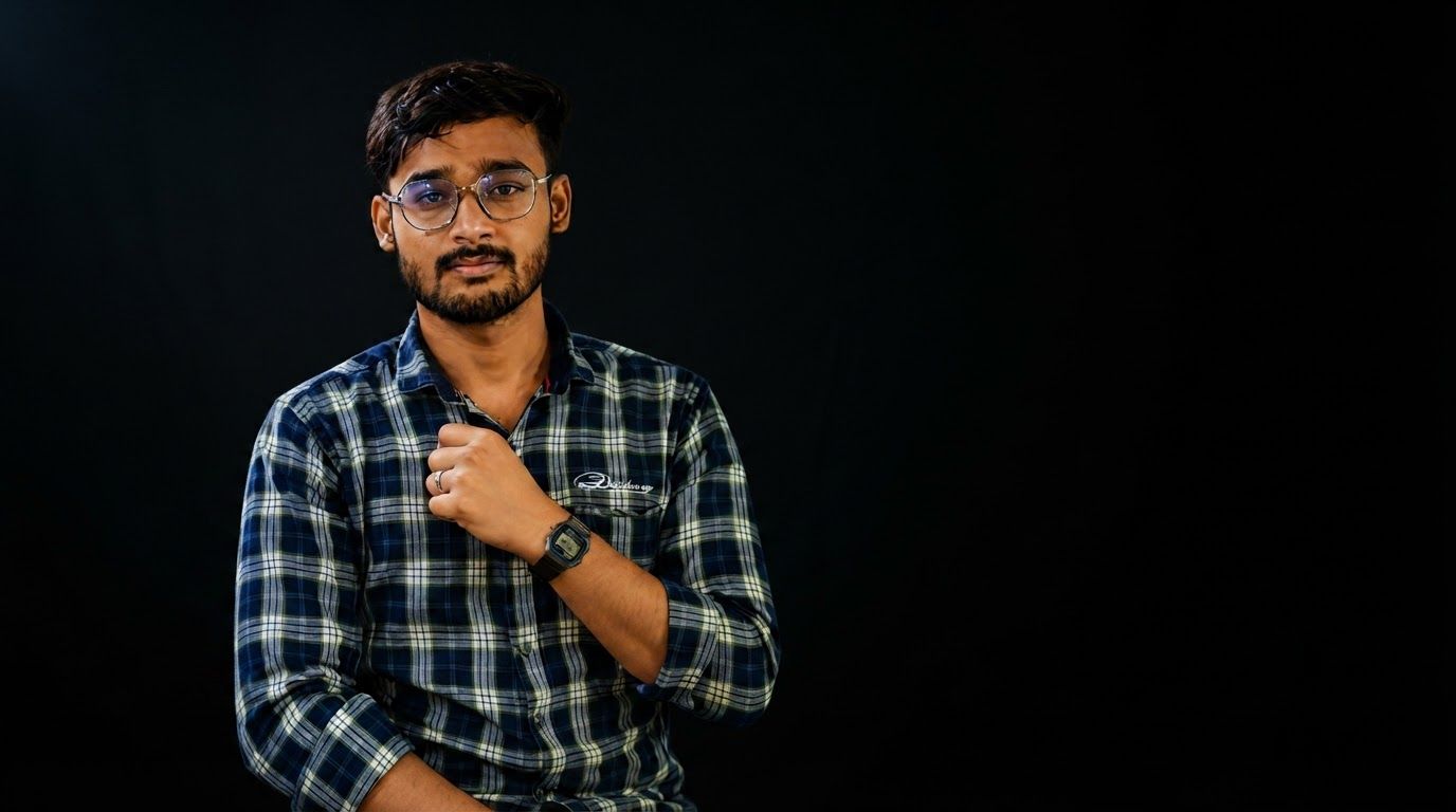 AI Design for Wide campaign hero photograph for Plaid Button-Down Shirt. A medium shot of a young man with a beard and glasses wearing a blue and white plaid button-down shirt. The subject is posed with one hand near his chest, set against a solid black background. Premium advertising composition with the product as focal point, cinematic lighting, clean negative space on one side for copy to be added later, no rendered words or logos beyond the reference product.
