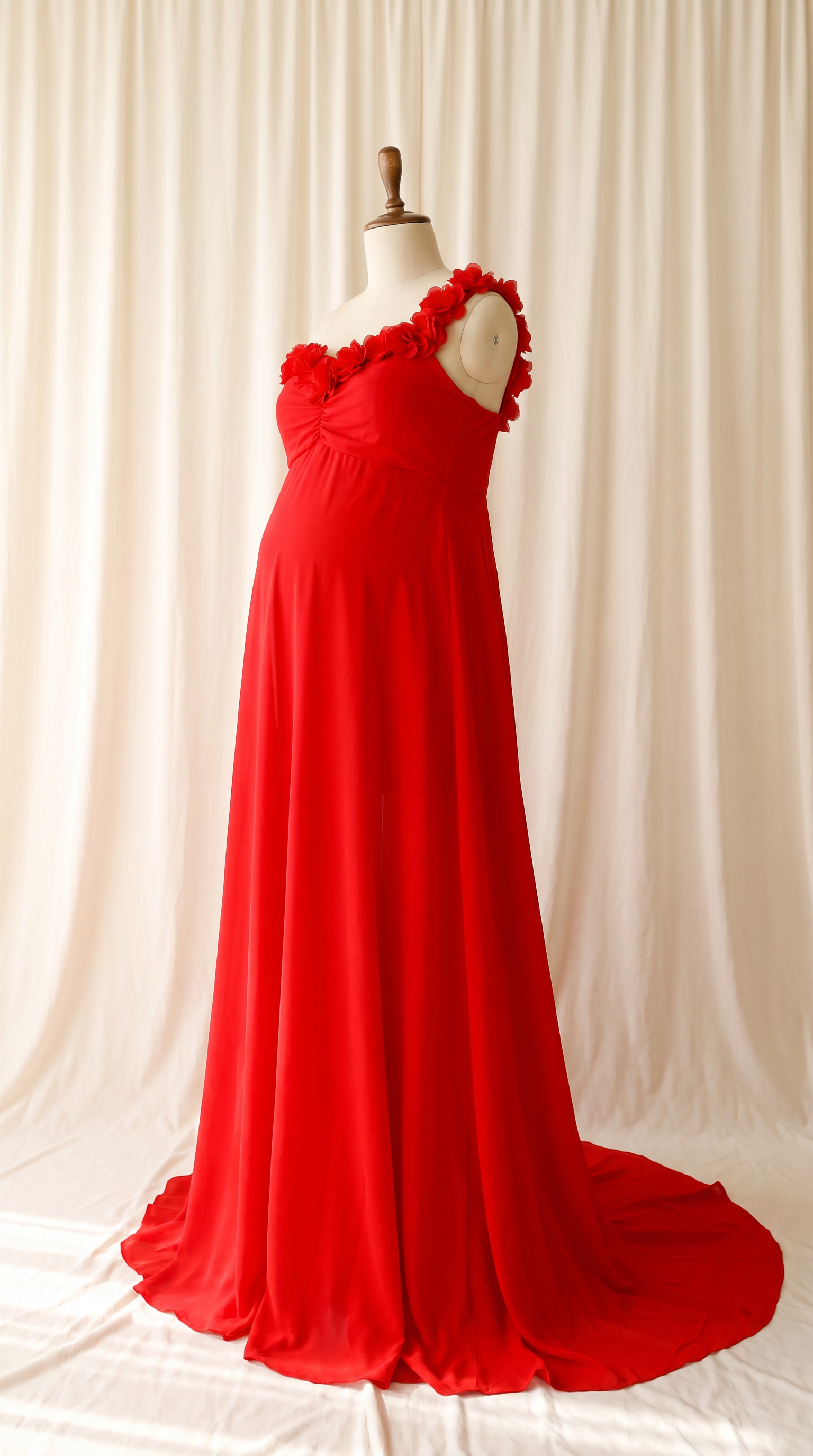 AI Design for 

{
  "task": "Reference-guided maternity garment transfer and studio background replacement",
  "reference_image": "[Attach the original maternity dress photograph]",
  "prompt": "Create a photorealistic maternity fashion product photograph using the attached image as the authoritative garment reference. Transfer the existing dress onto the specified pregnant tailor's dress form; do not create a similar dress, reinterpret the design, beautify it, or redesign it. Change only the original wearer or display form and the surrounding environment. Garment fidelity takes priority over styling and aesthetics. Follow the preservation, mannequin, background, lighting, and framing requirements below.",
  "garment_preservation": {
    "preserve": "Match the visible reference faithfully: hue, saturation, tonal relationships, fabric texture and weight, weave, sheen, transparency, print scale and placement, lace motifs, embroidery, embellishments, seams, neckline, bodice construction, waistline, sleeve cut and length, cuffs, hem, skirt volume, dress length, and any existing train.",
    "fit_and_drape": "Allow only the physically necessary changes in folds and tension caused by fitting the garment to the pregnant form. Preserve the garment's construction and overall silhouette. Fabric must respond naturally to gravity and belly volume, without stretching prints, melting lace, or distorting seams. Support the sleeves naturally without visible arms, hands, rods, or stuffing.",
    "uncertainty": "Do not invent decorative details or unseen garment construction. Keep the reference viewing angle where possible. If the hem or train is cropped out, preserve a comparable crop rather than inventing its appearance. Do not add a train if none is shown."
  },
  "mannequin": {
    "type": "Classic vintage tailor's dress form with a realistic pregnant torso and softly rounded belly, standing upright and centered.",
    "finish": "Matte cream-ivory linen-covered body, gently rounded shoulder ends, and a small round natural-wood neck cap. No head, facial features, arms, hands, human skin, glossy plastic, or exaggerated anatomy.",
    "visibility": "The dress remains the visual focus. Show the form only where the garment naturally exposes it; do not alter the neckline or opacity to hide it. Keep any support discreet and mostly concealed by the garment."
  },
  "background": "A plain warm off-white ivory fabric curtain with soft vertical folds and subtle vintage texture, clean and unpatterned. Matching ivory fabric continues onto the floor in gentle natural folds, creating visual continuity without a hard horizon line. No furniture, props, decorative architecture, or additional objects.",
  "lighting": "Large, soft, diffused daylight from slightly above and to one side; gentle fill, delicate contact shadows, and natural depth. Neutral white balance preserves garment color. Maintain separation between the dress and ivory backdrop without changing either color. No harsh shadows, clipped highlights, strong color casts, or artificial glow.",
  "composition": "Portrait framing, centered subject, straight verticals, realistic proportions, and minimal perspective distortion. Show the complete dress and existing train when supported by the reference, with modest breathing room. Preserve a cropped composition when required to avoid inventing missing garment details.",
  "output": {
    "aspect_ratio": "16:21",
    "orientation": "portrait",
    "style": "High-detail photorealistic product photography; crisp textile detail, natural tonal transitions, no CGI appearance."
  },
  "negative_prompt": "human model, head, face, hair, arms, hands, exposed human skin, non-pregnant torso, oversized belly, glossy plastic mannequin, redesigned dress, altered neckline, missing sleeves, added sleeves, changed hem, invented train, changed color, incorrect print scale, misplaced pattern, missing embellishments, added decorations, warped seams, melted lace, floating fabric, artificial transparency, clutter, furniture, luxury interior, text, logo, watermark, harsh flash, yellow color cast, oversaturation, blur, excessive smoothing, CGI, illustration"
}

