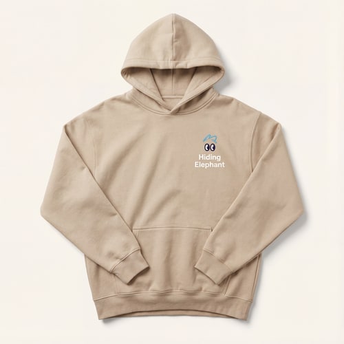 AI Design for Minimalist studio product photo of a beige oversized hoodie, front view, no model.
Clean soft fabric texture, realistic folds and seams, premium streetwear quality.
Apply subtle branding inspired by the “Hiding Elephant” logo:
— small playful eye icon placed on the chest (left side),
— soft rounded shapes, friendly character style,
— brand name “Hiding Elephant” in clean sans-serif typography.
Branding color palette:
soft sky blue and dark navy accents, matching the logo style,
print looks like high-quality screen print or embroidery.
Lighting:
soft diffused studio light, gentle shadows, high realism.
Background:
light neutral background (off-white / very light gray),
no gradients, no patterns.
Ultra realistic product mockup, fashion catalog style,
sharp focus, high detail, professional e-commerce photography.