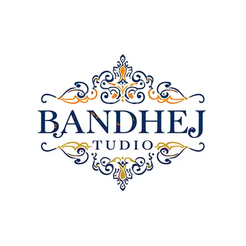 AI Design for Wordmark logo for a sari shop named "BANDHEJ STUDIO": featuring intricate, flowing typography that evokes the artistry of bandhej dyeing, paired with subtle geometric motifs inspired by traditional Indian patterns. Color palette of deep indigo, saffron, and gold, with accents of cream. Typography should be elegant and slightly calligraphic. Design with a focus on heritage and luxury, with a modern, sophisticated visual execution. Incorporate subtle textures that mimic woven fabric. White background.