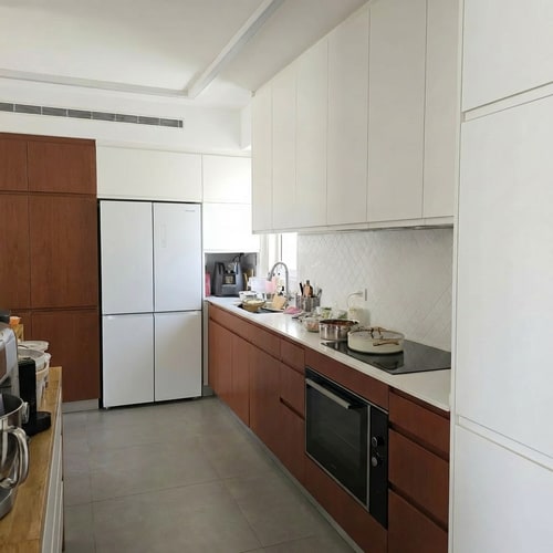 AI Design for Change the refrigerator color to white.
• Reduce the refrigerator depth so it is fully flush with the cabinetry. Currently, the refrigerator protrudes 10 cm beyond the cabinet line; it should not protrude at all.
• On the opposite side, change the finish of the tall cabinets to a brown tone.
• Lower the height of the tall cabinets so they match the height of the tall cabinets in the refrigerator area, creating one consistent height for all tall cabinets in the kitchen.
• Continue the wall line above the cabinets so it wraps around them, creating a framed and cohesive look.