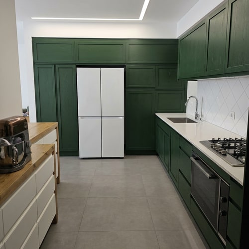 AI Design for A highly detailed, realistic modern kitchen interior focusing on the cabinetry and countertop area — Close-up, medium shot, straight-on view, maintaining realistic interior proportions — Cabinets rendered in a rich, deep, natural, realistic forest green; countertop surface is clean white; backsplash is bright ceramic — Soft, consistent, natural interior lighting that enhances texture and color depth — High-fidelity photorealism, architectural visualization quality — Backsplash must feature white ceramic tiles arranged in a prominent diamond pattern; cabinet color must be perceptibly darker and richer than the original natural green; maintain all visual consistency and realistic proportions — Modern kitchen setting.