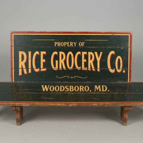 AI Design for A vintage wooden bench designed like an old general store advertising sign, viewed straight from the front (perfect frontal view, no perspective distortion). The top surface is flat and clearly visible like a signboard. It has hand-painted, slightly worn lettering in a classic 19th-century style. The main text reads “Rice Grocery Co.” in large, bold, warm yellow and red lettering. Above it in smaller text: “Property of”. Below it: “Woodsboro, MD.” The wood is aged, slightly weathered with visible grain and subtle paint wear. Colors are dark green, black, and rustic tones. The bench has simple wooden legs visible underneath. Lighting is soft and natural, background neutral and unobtrusive.