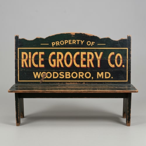 AI Design for A vintage wooden bench designed as an old general store advertising sign, perfectly front-facing (orthographic view, no perspective distortion). The bench looks symmetrical and centered. The top panel is clearly visible like a flat sign. Hand-painted vintage typography reads: “PROPERTY OF” (small, top), “RICE GROCERY CO.” (large, bold centerpiece in warm yellow/orange with red shading), and “WOODSBORO, MD.” (smaller below). The wood is aged and slightly worn with visible grain and distressed paint. Colors include dark green, black, and rustic tones. The bench legs are simple and visible beneath. Studio lighting, neutral background, highly detailed, realistic texture, no angle, straight-on view.