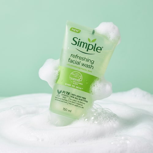 AI Design for Simple Refreshing Facial Wash placed slightly tilted on top of smooth white foam bubbles, airy lightweight foam texture surrounding the tube, soft diffused lighting, pastel mint background, gentle skincare mood, clean composition, realistic foam details, fresh and soothing skincare advertisement style