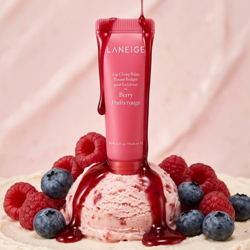 AI Design for Use the exact product image of Laneige Lip Glowy Balm Berry. Do not change packaging, logo, or color. Maintain original branding and text clarity. High-end luxury beauty campaign, soft studio lighting, ultra-realistic, macro photography, shallow depth of field.”Place the Laneige Lip Glowy Balm Berry on a scoop of strawberry ice cream. Add glossy berry syrup dripping over the product and ice cream. Surround with raspberries and blueberries. Soft pink pastel background, creamy texture, hyper-realistic, luxury cosmetic ad.”