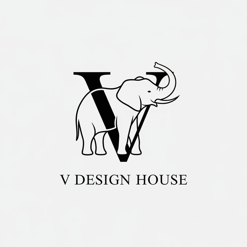 A stylized elephant outline forming the letter “V”

Thin, elegant lines

Elephant trunk curved upward (symbol of luck & prosperity)

Text below:

V Design House

Font style: Modern serif (luxury look)
