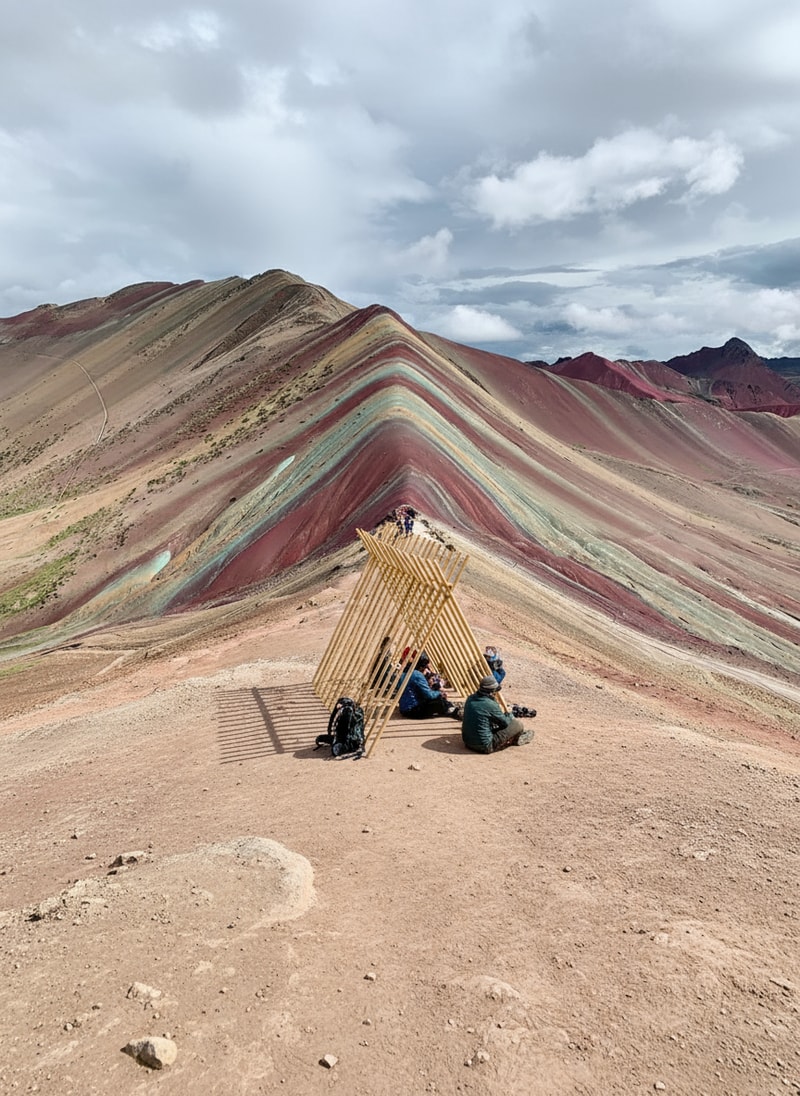 Add the pavilion from the second picture to the first picture and add hikers resting in it.