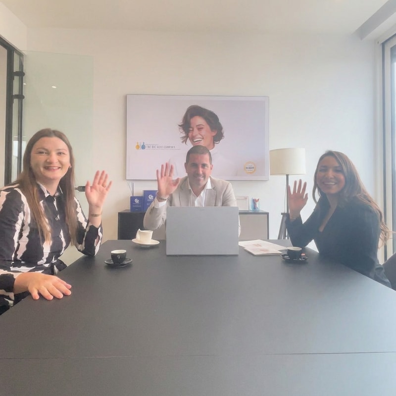 A group of people on the photo smiling and waving naturally. Their hands and arms have normal, natural proportions. No distortions, no exaggerated body parts, no surreal or artificial effects — just a lifelike, joyful moment of people smiling and waving. just they look at camera, smile and wave,and thats it