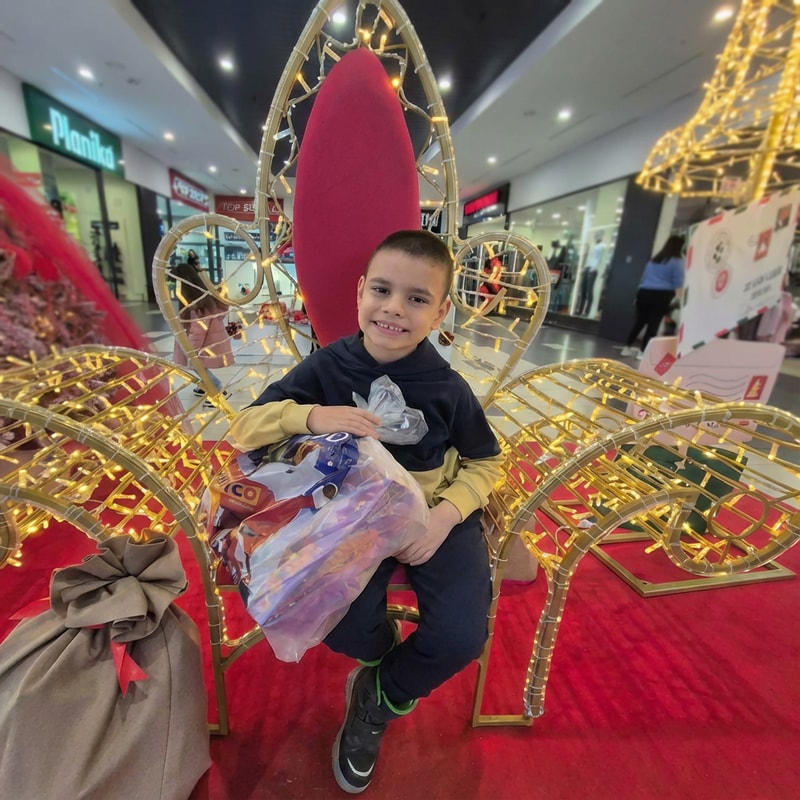 blur  more so i cant see the stores behind the background. let the boy be in focus and enhance quality of photo