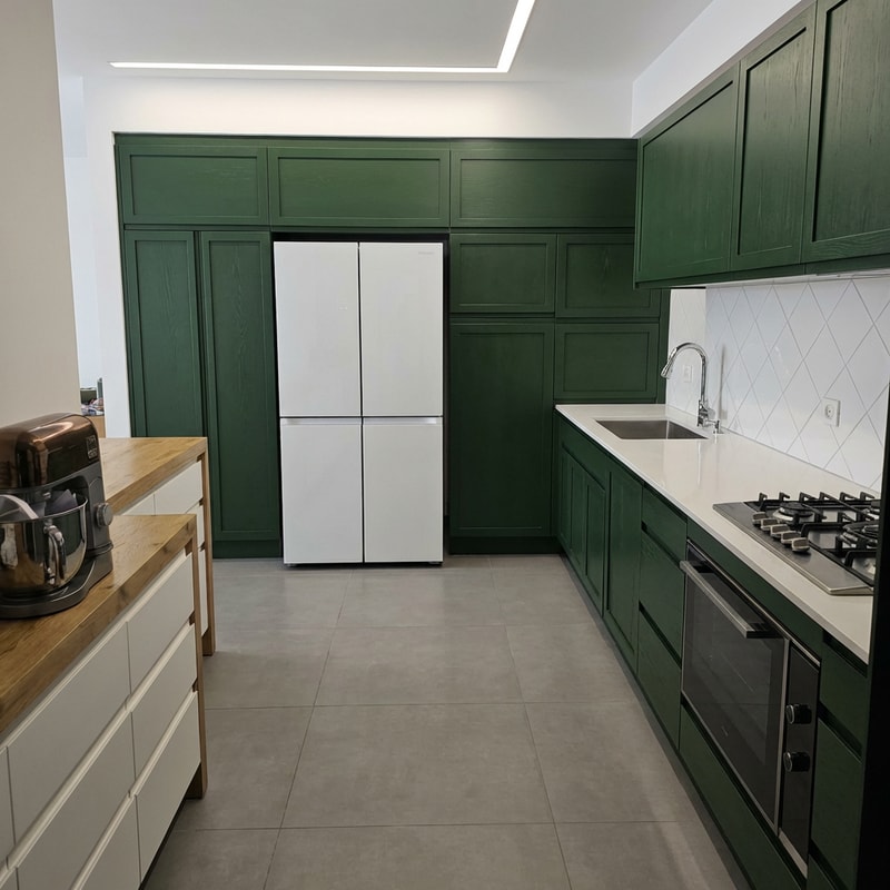 A highly detailed, realistic modern kitchen interior focusing on the cabinetry and countertop area — Close-up, medium shot, straight-on view, maintaining realistic interior proportions — Cabinets rendered in a rich, deep, natural, realistic forest green; countertop surface is clean white; backsplash is bright ceramic — Soft, consistent, natural interior lighting that enhances texture and color depth — High-fidelity photorealism, architectural visualization quality — Backsplash must feature white ceramic tiles arranged in a prominent diamond pattern; cabinet color must be perceptibly darker and richer than the original natural green; maintain all visual consistency and realistic proportions — Modern kitchen setting.