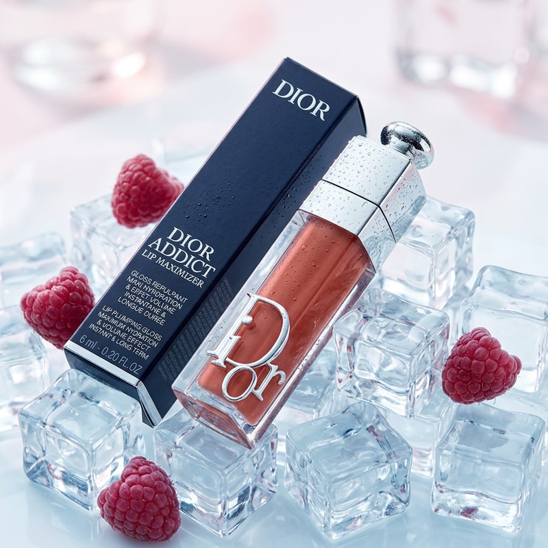 Luxury Dior lip gloss placed on crystal clear ice cubes, frosty cold aesthetic, soft white and pastel pink tones, fresh raspberries scattered, condensation droplets, minimal clean composition, high-end cosmetic ad, studio lighting, sharp focus with soft blur background
IMPORTANT: Do not alter Dior product design, logo, text, or shade. Keep packaging identical and realistic.