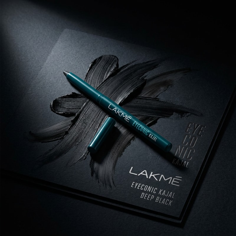 Smudge Beauty Shot

“Create a luxury beauty ad of Lakmé Iconic Kajal with bold smudge strokes around it.
Black kajal texture spread artistically like brush strokes.
Minimal background, spotlight lighting, elegant shadows, editorial makeup campaign style.
High detail, realistic texture, premium aesthetic.”

black colour kajal